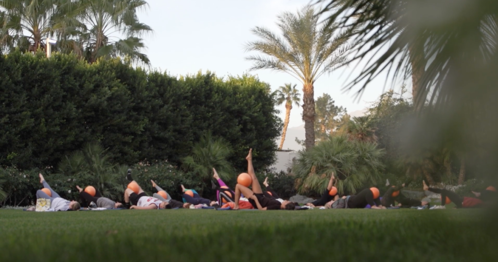 Attendees Thinking Outside the Ballroom while doing yoga.